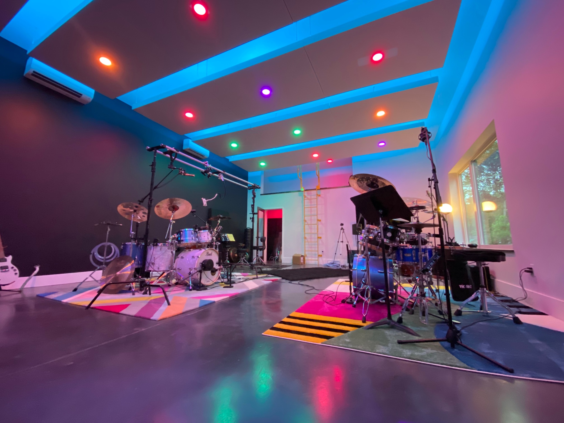 Poolehaus live room lit in blue, red, and purple